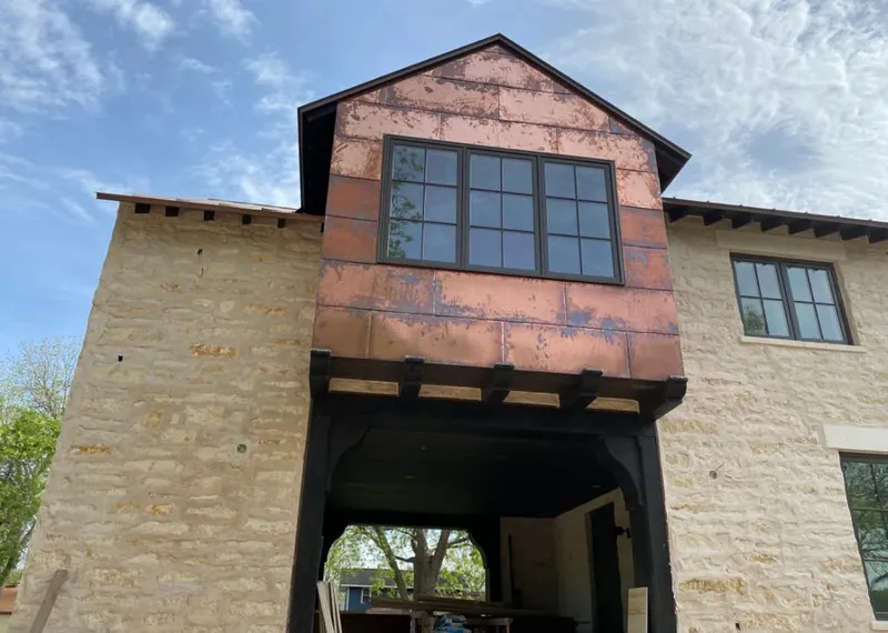 Copper metal panel facade on a stone building for Skylight Installation in San Clemente